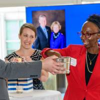 woman draws a raffle ticket from a bucket